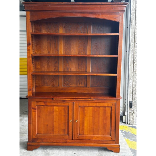 Large two-part library in solid cherry wood with sliding writing surface, French manufacture of fine quality, second half...