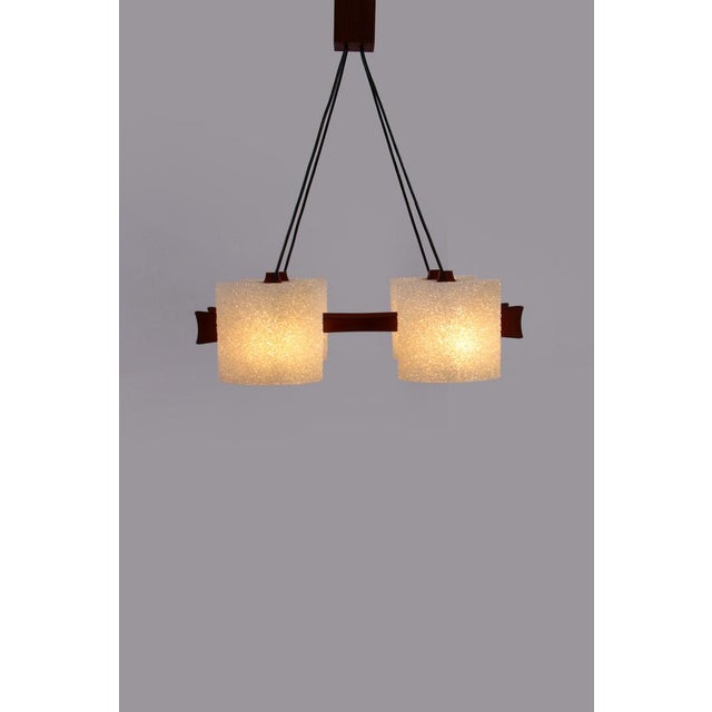 This is a beautiful hanging lamp with four lampshades and an e14 fitting. The wood is teak and the caps are made of a kind...