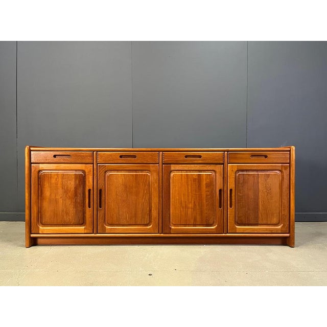 Mid century teak credenza or sideboard by Dyrlund wioth 4 doors and 4 door drawers offering plenty of storage space. The...