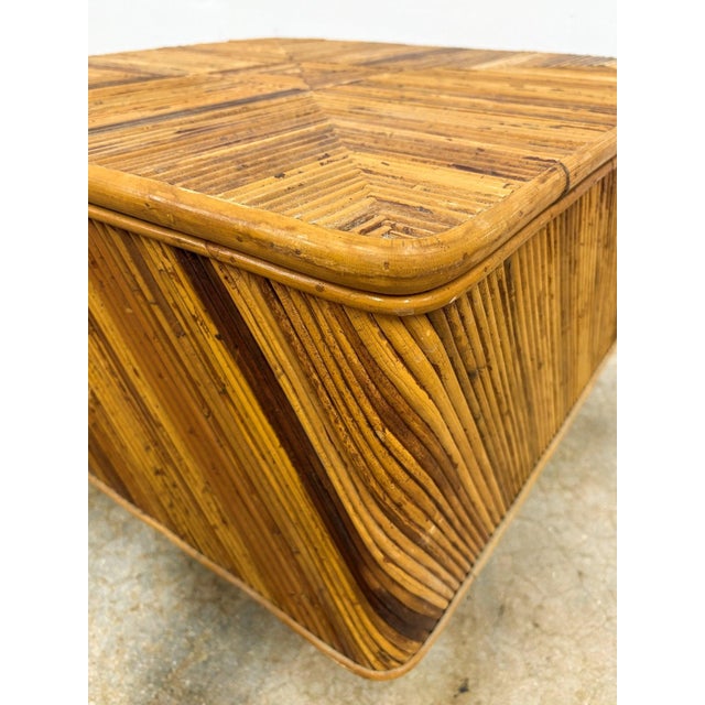 This Petite Square Pencil Reed Coffee Table features intricate pencil reed wrapping and a sleek platform base, bringing...