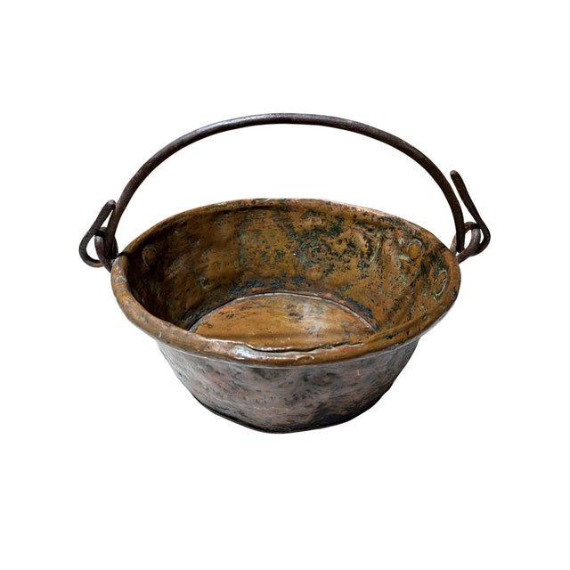 This French copper pan showcases the patina and character of age, making it a striking decorative accent for any kitchen....