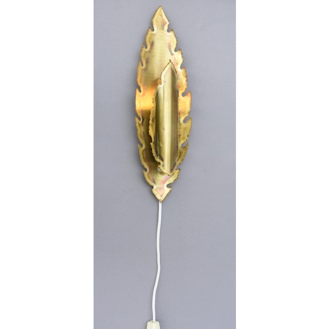 A rare leaf wall lamp, model 5304, designed by svend aage holm-sørensen and produced in denmark. the lamp features a long,...