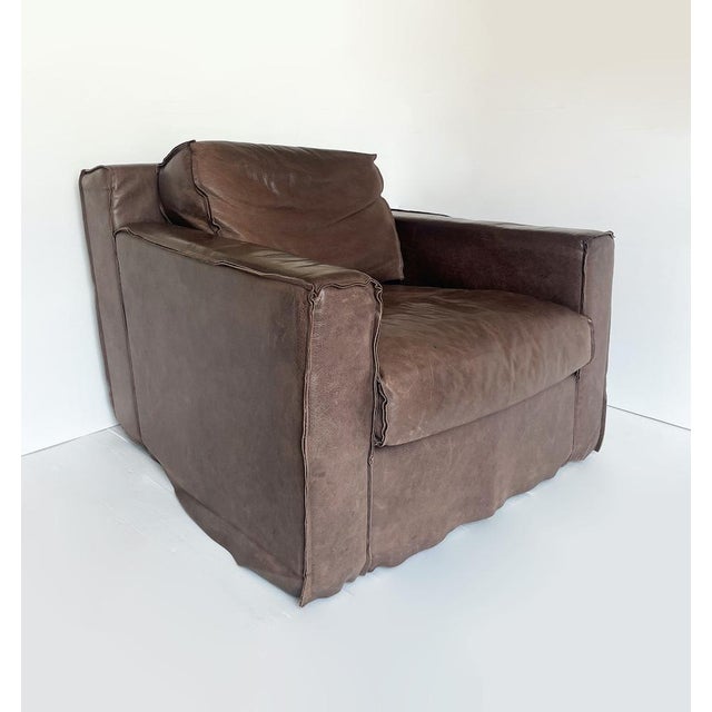 Unique, large armchairs, made in italy, entirely upholstered in brown leather with a uniform patina, and a solid wood...