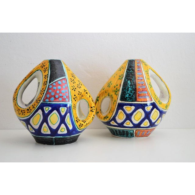 Beautiful set of two colorful pieces ceramic vases or vessels with typical pattern from the midcentury, approximate...