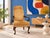 A vintage Queen Anne leg armchair featuring a vibrant orange and brown striped velvet upholstery with brass nailhead trim....
