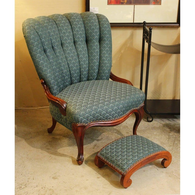This vintage upholstered piece features a distinctive channel-back silhouette with a scalloped profile and carved wood...