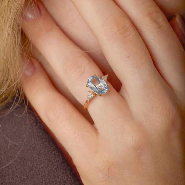 This striking modern ring is a refined celebration of color, geometry, and contemporary craftsmanship, centered around a...