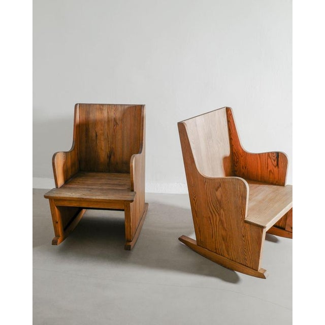 A very rare and sculptural pair of swedish modern "lovö" rocking chairs in stained pine wood by axel einar hjorth and...