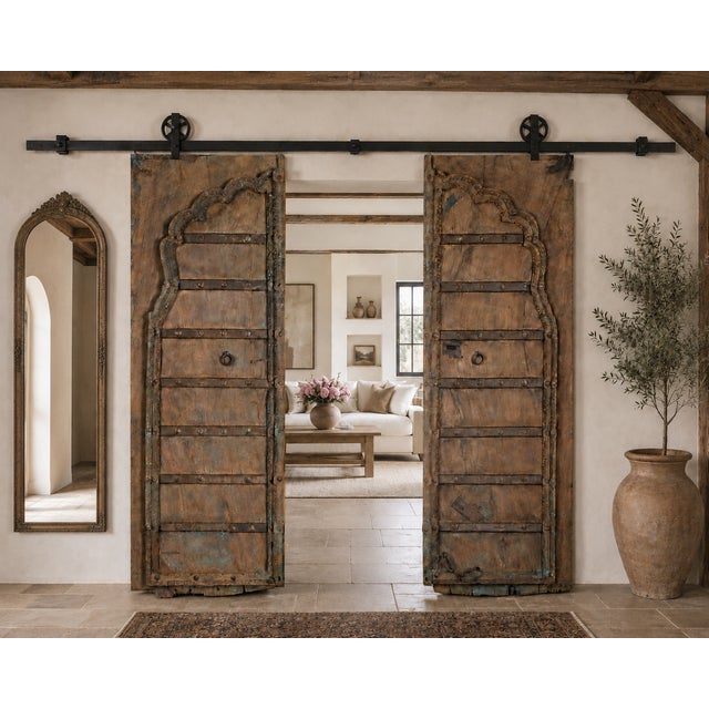 Antique Indian Carved Teakwood and Iron Door, the top with a shaped arch, with a carved outline and center style. A very...