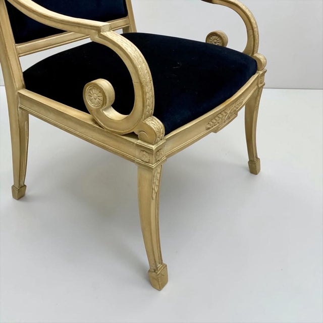 This is a pair of mid-century French neo-classical style carved beech bergere chairs in a navy velvet. The frames have...