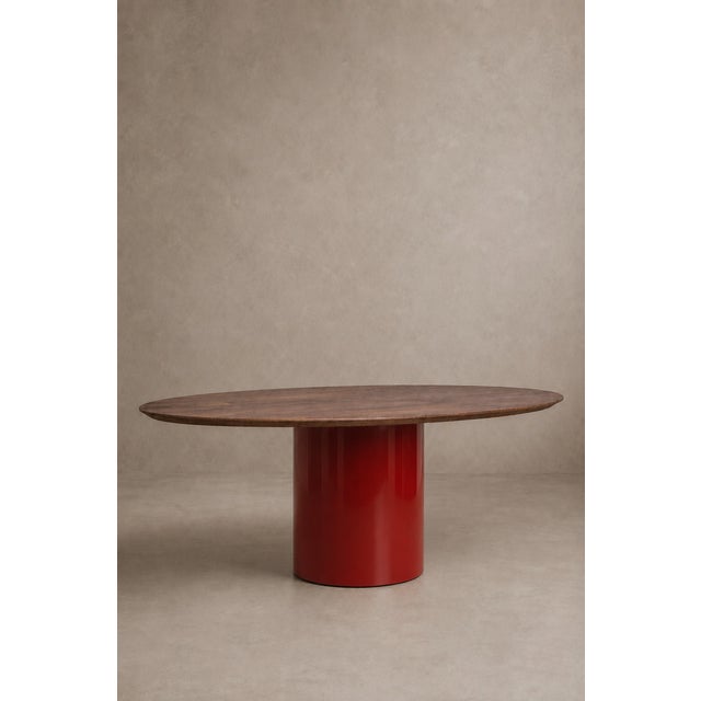 A sculptural table, defined by the encounter between the natural richness of solid walnut and the graphic presence of the...