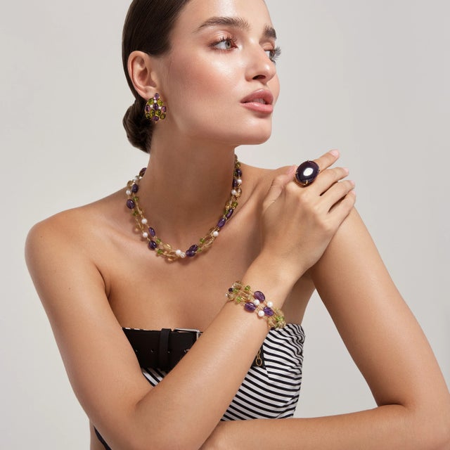 The Celine Ring embodies understated elegance, boasting a generously sized oval semi-precious stone available in a range...