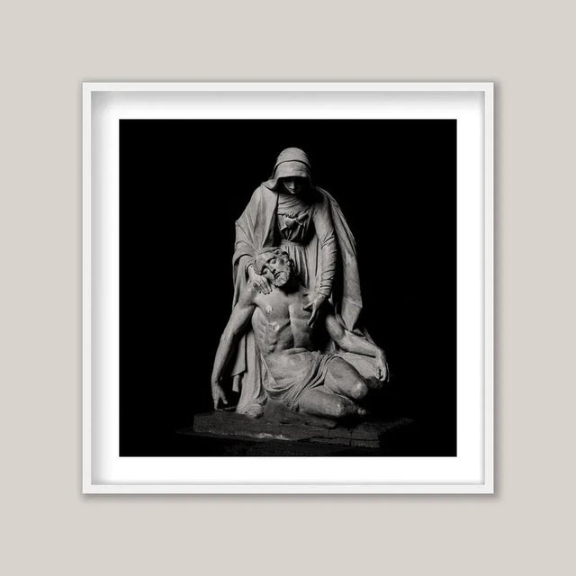 A poignant sepia-toned photograph captures a majestic and elegant statue of Jesus Christ, moments after being taken down...