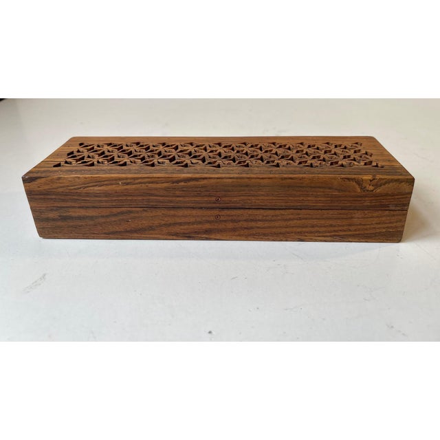 A beautifully crafted rosewood box filigree lid and pin-inlays. Suitable for pens, pencils or potpourri. It was made in...