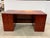 Design Plus Gallery presents a Transitional Cherry Stain Executive Desk. This desk has a streamlined transitional profile...