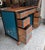 Beautiful hand painted vintage pedestal desk featuring a rich walnut wood top and drawer fronts, deep teal side panels,...