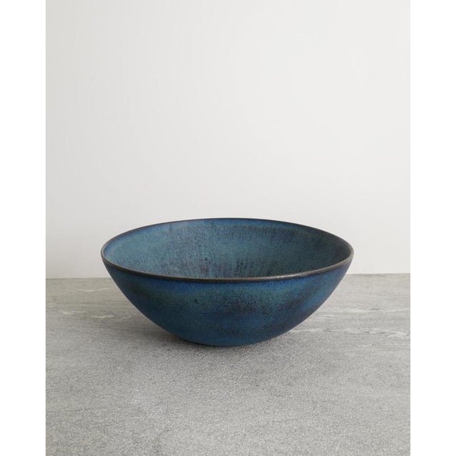 A rare oversized Swedish mid century decorative large ceramic bowl in a blue glaze with light brown impressed and...