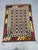 This Afghan Chobi flatweave kilim features a cream field with repeating colorful geometric motifs in rust orange,...