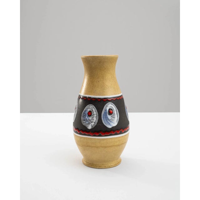 Bask in the radiant charm of this 1960s German "W. Germany" Ceramic Vase, resplendent in a vibrant shade of yellow. A...