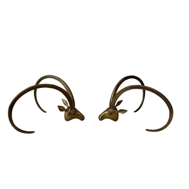 Sculptural and striking, this pair of vintage brass coffee table bases features bold ibex or ram’s head motifs,...