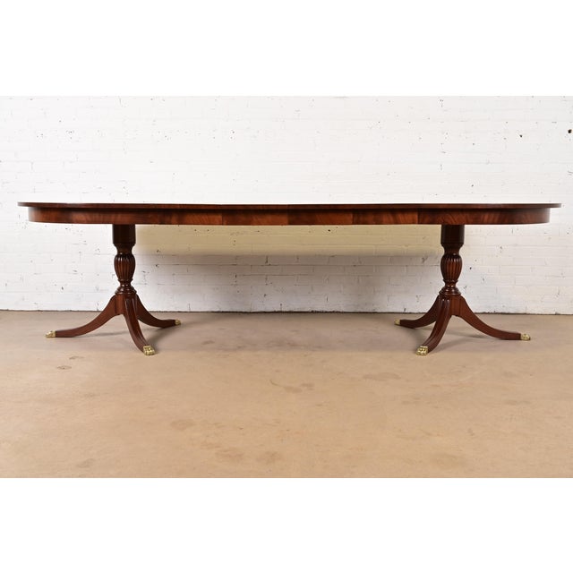 An exceptional Georgian or Regency style double pedestal extension dining table By Henkel Harris USA, 1978 Gorgeous book-...