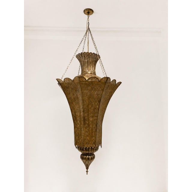 Monumental vintage Moroccan pierced-brass chandelier, handcrafted in Marrakech, Morocco, circa 1980s. This oversized...