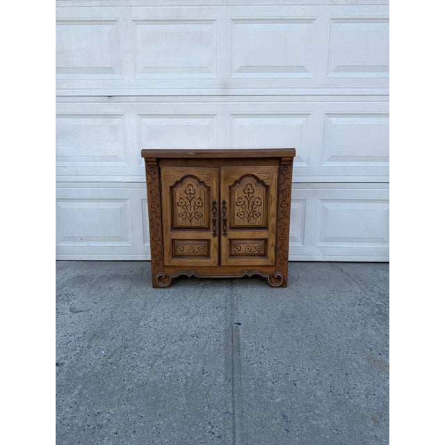 We have a beautiful vintage French Provincial carved oak cabinet for sale. It features beautiful floral detailing, paneled...