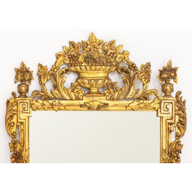 Rococo Style Giltwood Framed Mirror, urn form crest and Greek key details at corners. Mirror plate: 37.25" H x 23.25" W;...