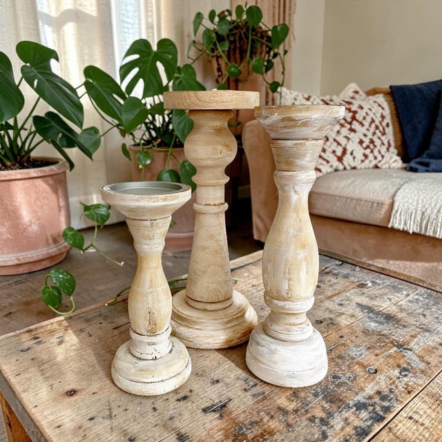 Transform your living space with our White Washed Shabby Chic Wooden Pillar Candle Holders, a set of three that...