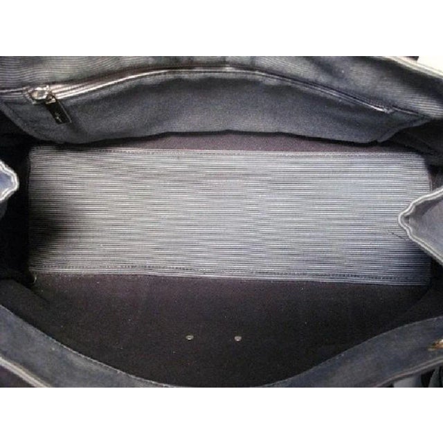 This fun Ferragamo tote is in excellent Vintage Condition. The exterior features pin striped navy and grey woven canvas...