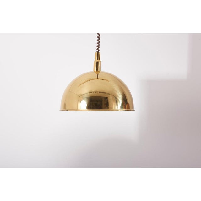 Adjustable pendant lamp by Florian Schulz. The Lampshade measures 41cm in diameter and 22cm in height. The total height is...