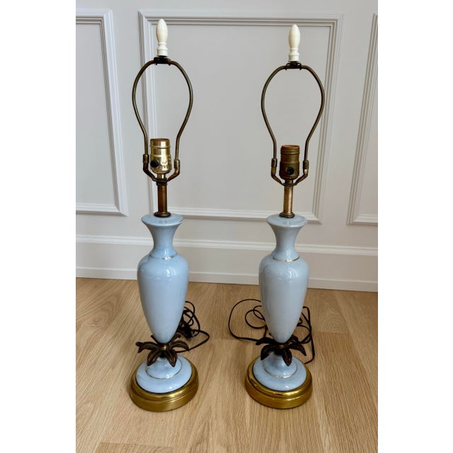 Elegant pair of vintage table lamps crafted from pale powder-blue opaline glass with delicate gilt detailing, gilt-metal...
