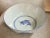 Blue and white porcelain bowl from China, made in the 1980s. Koi fish adorn the exterior of the bowl while one lone fish...