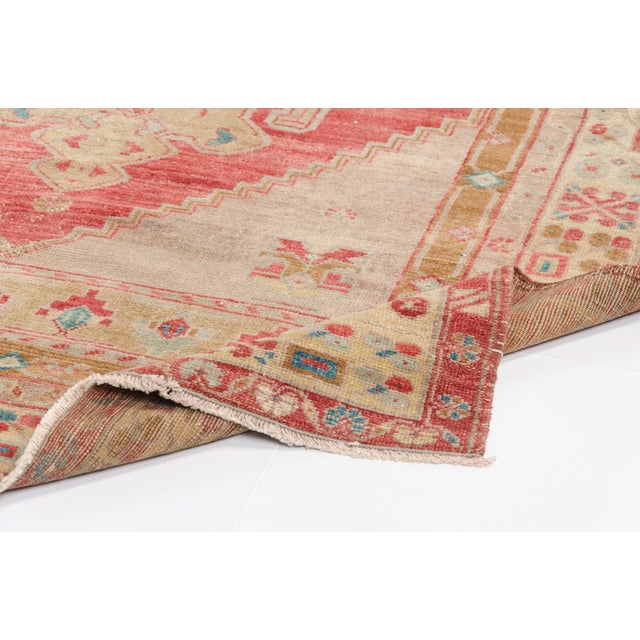 This is a vintage Turkish Oushak rug from the 1960s. The piece was hand-knotted.