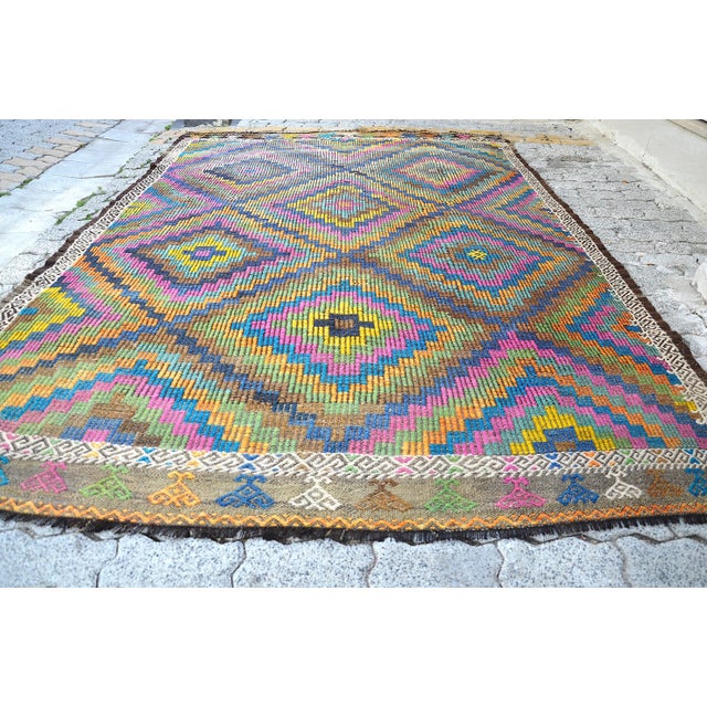 This is a vintage Turkish Anatolian kilim rug from the 1960s. The piece was hand-woven.