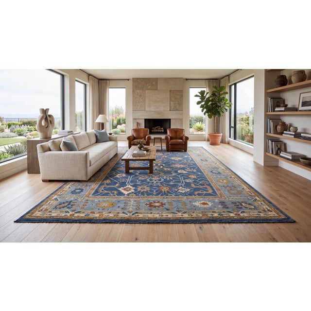 Elevate high-end interiors with this hand-knotted modern Oushak-style area rug, featuring a rich indigo blue field woven...