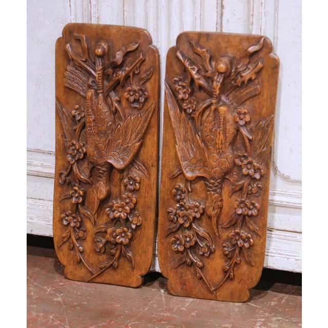 This pair of antique carved wooden wall panels was crafted in France circa 1920. Hand-carved in high relief from solid...