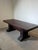 Beautiful antique solid oak dining table featuring a robust construction and rich, dark patina. The table stands on two...