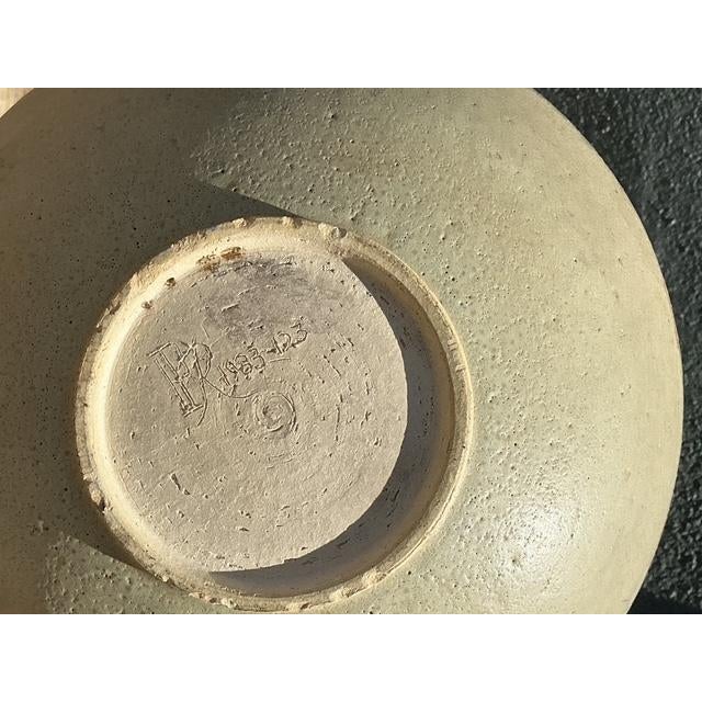 This exceptional vintage studio pottery bowl, dated 1983, is a masterclass in organic texture and reactive glazing. The...