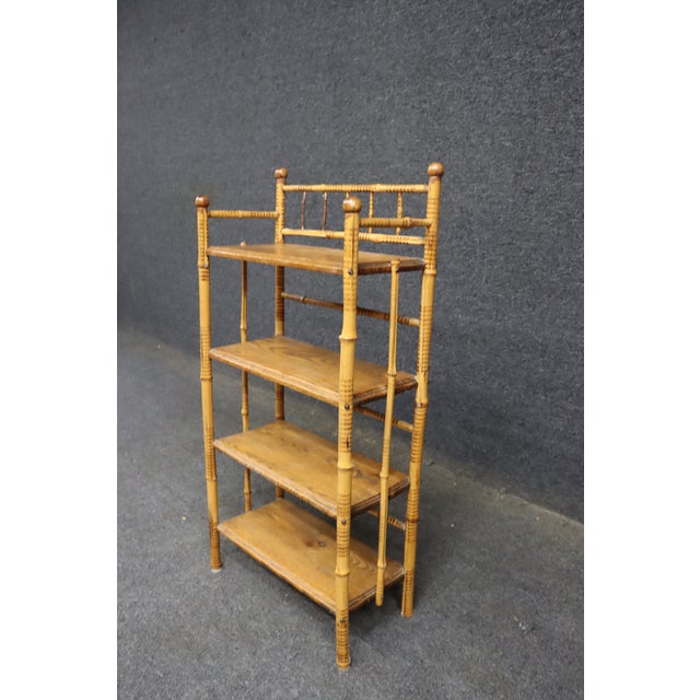 Victorian etagere featuring a burnt bamboo frame with turned detailing, rounded finials, and four quarter-sawn oak...