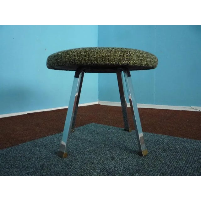 This very rare stool originates from the 1950s and is made from a chromed metal frame with brass details and features a...