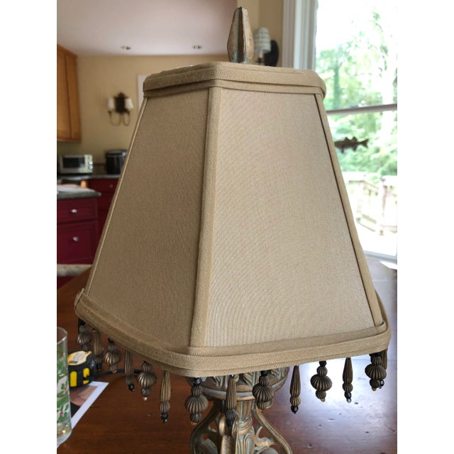 Lexington brand lamp with acanthus motif purchased at Mathew’s Furniture in Atlanta. Feet of lamp base are covered in...
