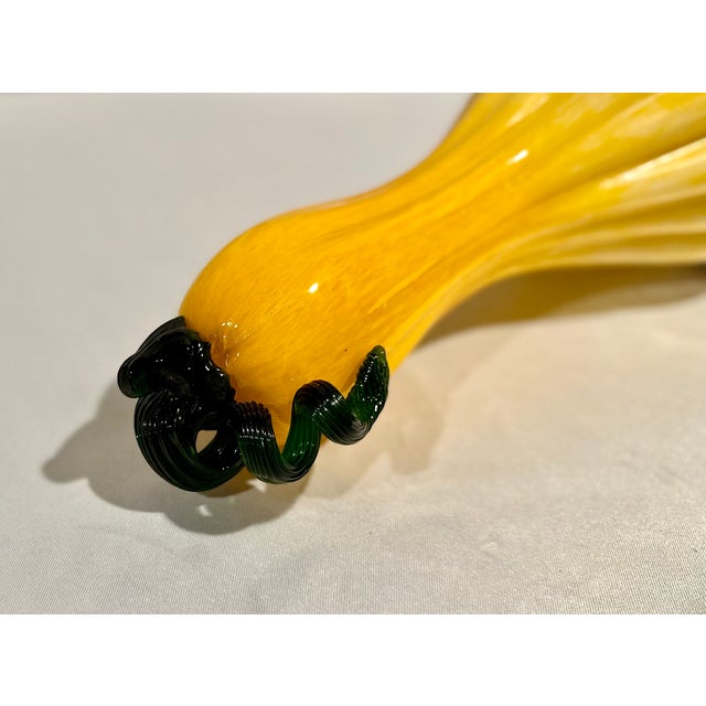 Adorn your fall buffet with this large scale Art glass gourd in mottled shades of yellow and brown with a twisted green...