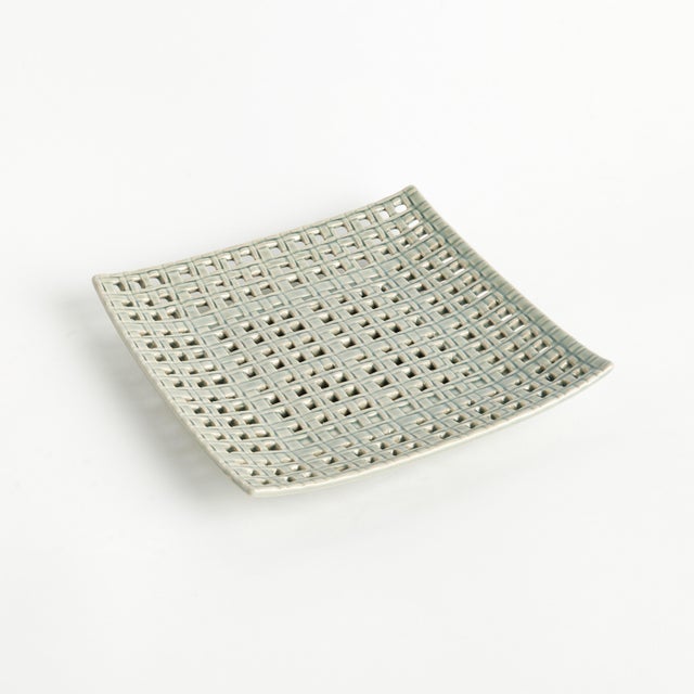 This tray is gorgeous as a centerpiece, or to hold a large vase or sculpture. The , open weave, stoneware design is...