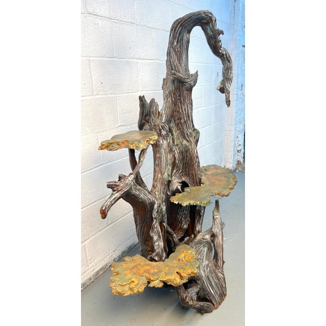 This tall tree shelf has been made from repurposed wood with three shelves made of burled wood. This contrast makes for an...