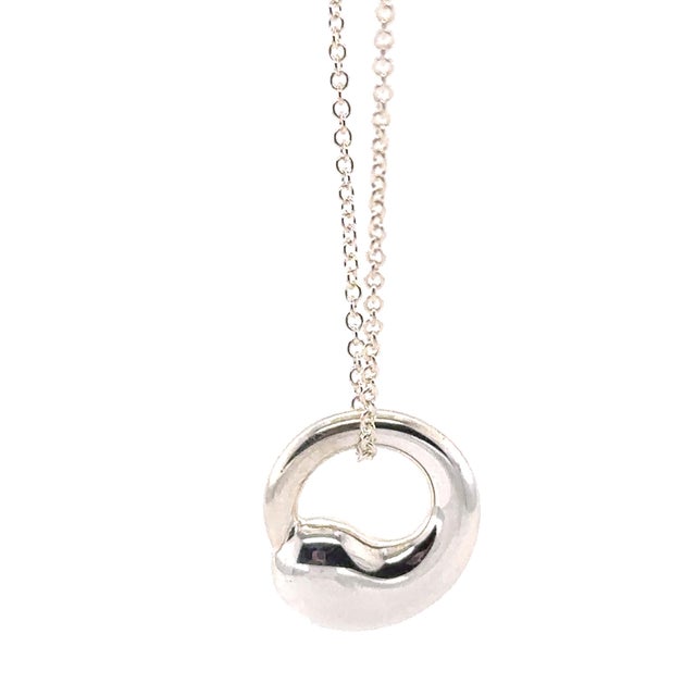 A timeless Tiffany & Co. Elsa Peretti Eternal Circle pendant necklace crafted in sterling silver, featuring the designer's...