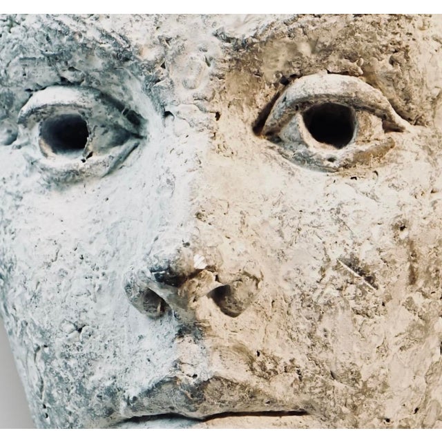 A weighty, atmospheric zinc bust of a young woman, cast with a soft, almost hand-modeled quality unusual for metal work —...