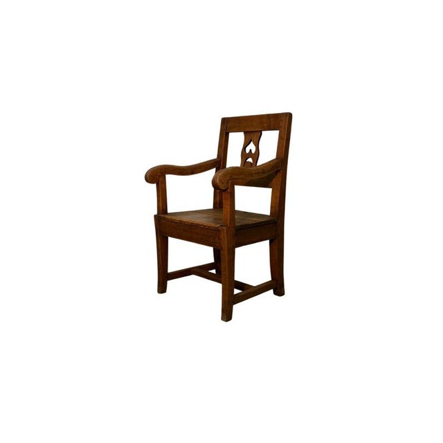 Antique walnut armchair dating back to the 19th century, featuring a solid frame and a decorated backrest that gives the...