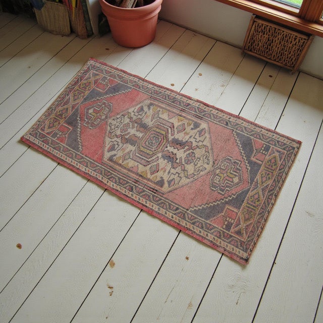 Vintage Turkish hand-knotted small rug from Oushak, 1970s, featuring warm faded rose tones and authentic village...