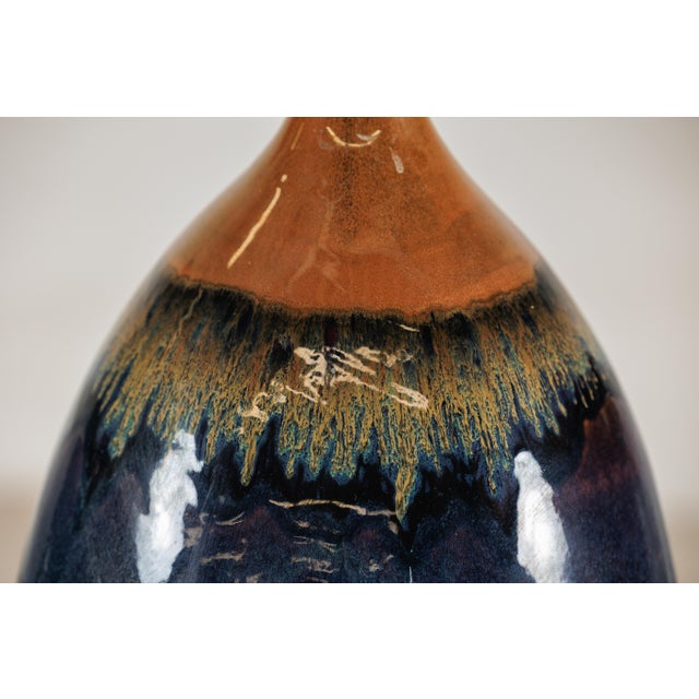 "About the Item This large artisan-crafted ceramic vase presents a striking study in proportion and glaze. The elongated,...